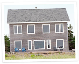 A house with two chairs in front of it.